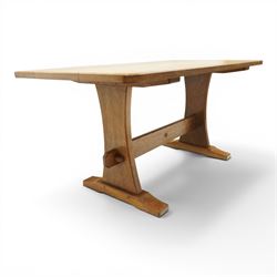 Acornman - 5' adzed oak dining table, rectangular top above a trestle base united by a stretcher with carved acorn signature, by the workshop of Alan Grainger of Brandsby