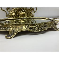 Ornate brass centrepiece, with twin handled vase upon a mirrored base, with floral and scrolling decoration, H23cm 