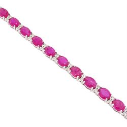 18ct white gold ruby and diamond bracelet, twenty-six oval cut rubies, each spaced by two round brilliant cut diamonds, hallmarked, total ruby weight approx 9.40 carat, total diamond weight 0.50 carat