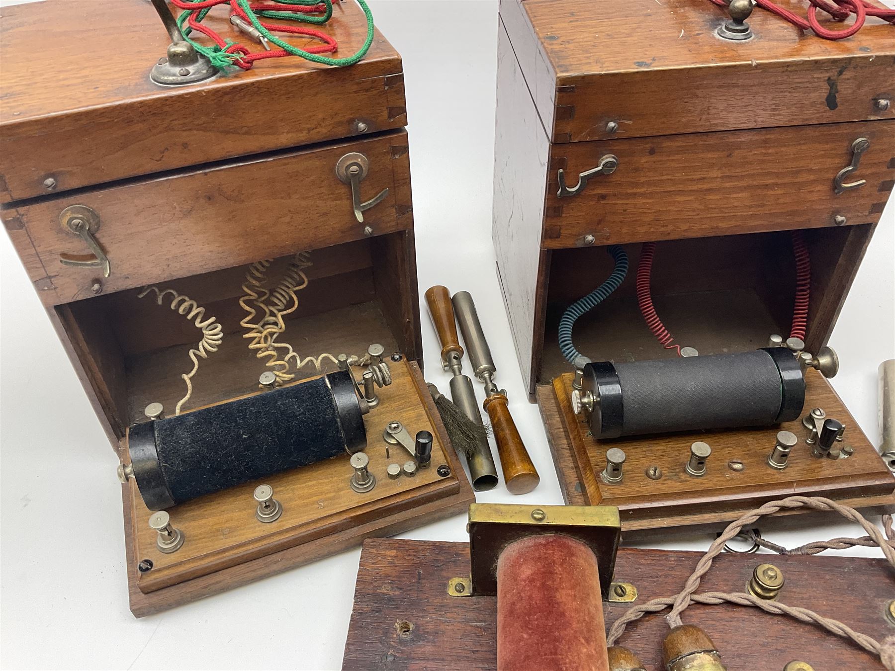 Heeling Error Instrument Patt.5 No.1613E (box numbered 1810E) with integrated spirit level D11cm; two walnut cased electric shock machines; and a similar board mounted electric shock machine (4)