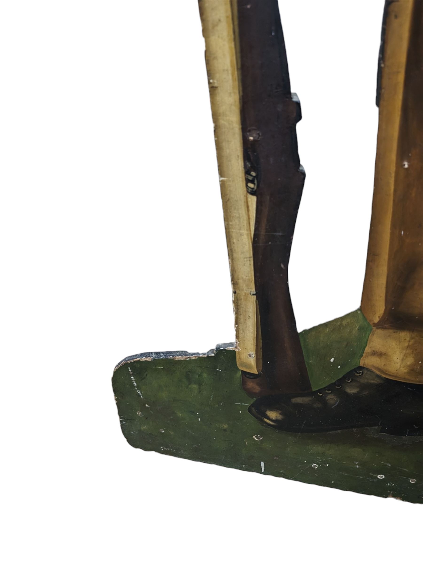 Military Outfitters hand painted life size wooden cut out figure of a WW1 soldier standing at ease holding a gun by his side, marked Stening Signs; hardboard on planked frame H199cm