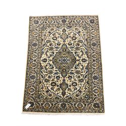 Fine Kashan ivory ground rug, central medallion on floral field, repeating boarder 