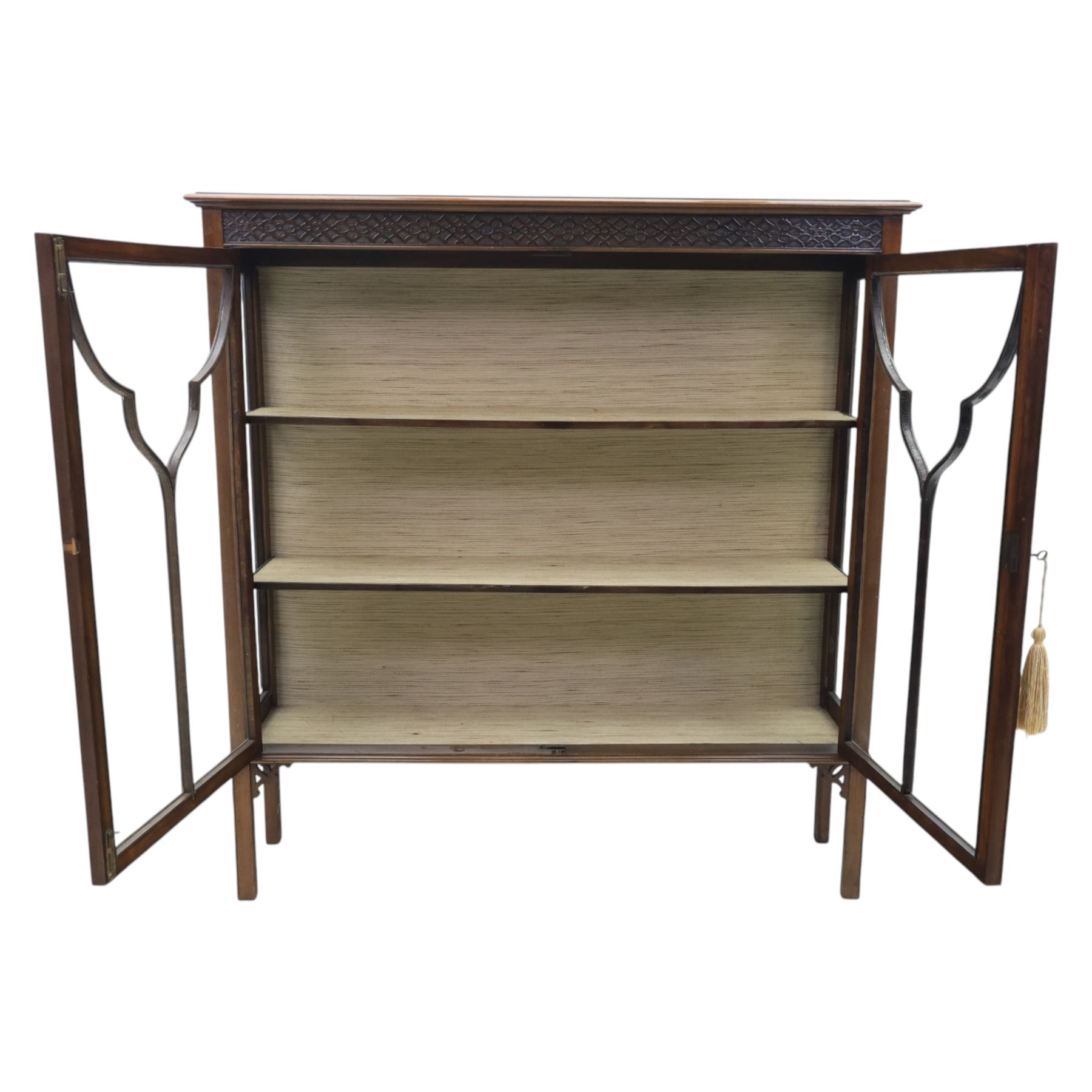 Edwardian mahogany display cabinet, blind-fretwork frieze over astragal glazed doors, square legs with fretwork detail