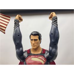 Composite Superman with cape, together with a composite female statue holding the American flag, tallest example H103cm