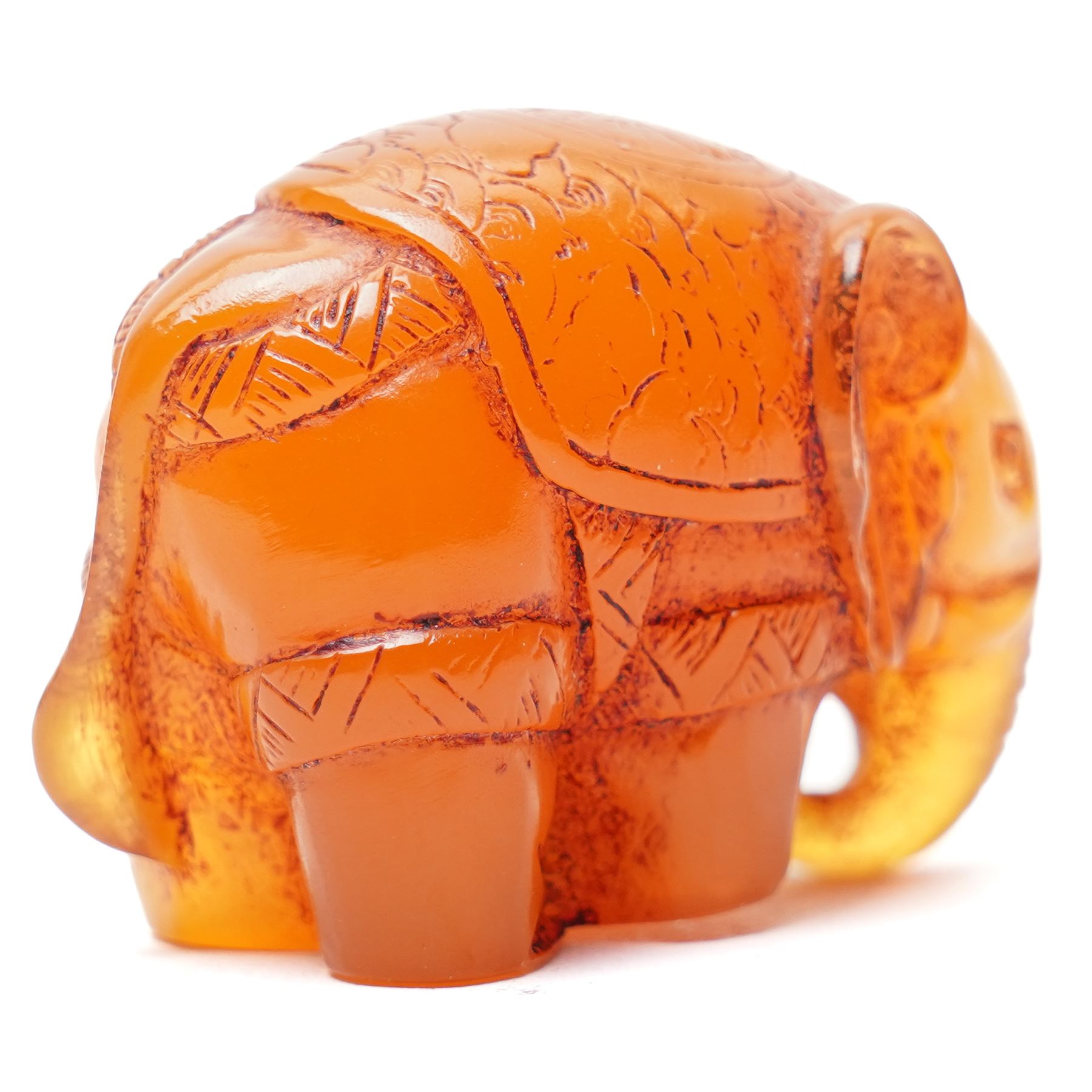 Japanese Meiji period carved amber netsuke in the form of an elephant, signed with single character mark to base, W4cm