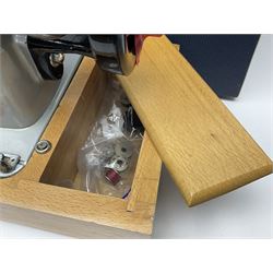 Seamstress sewing machine in case, together with a Singer sewing book