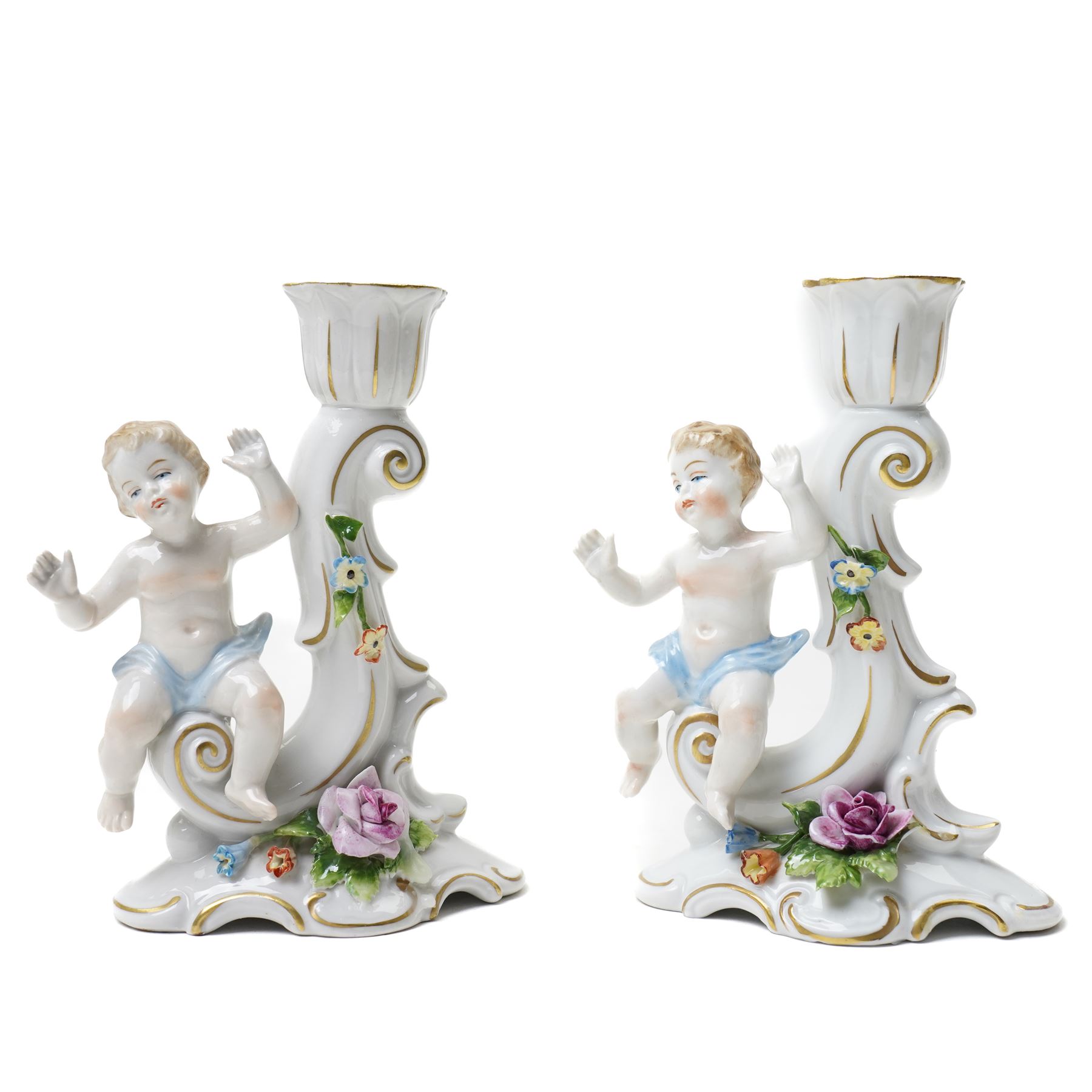 Collection of German and continental porcelain figures, including a figure of Juno with peacock, two figures feeding birds on benches, cherub candlesticks, and others