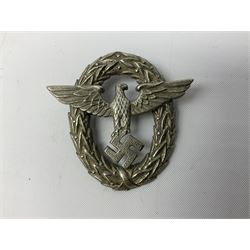 Three WW2 German visor cap badges comprising Police eagle, Political leaders eagle and Norwegian Quisling Party; all with fixings; and WW2 Polish visor cap badge (4)