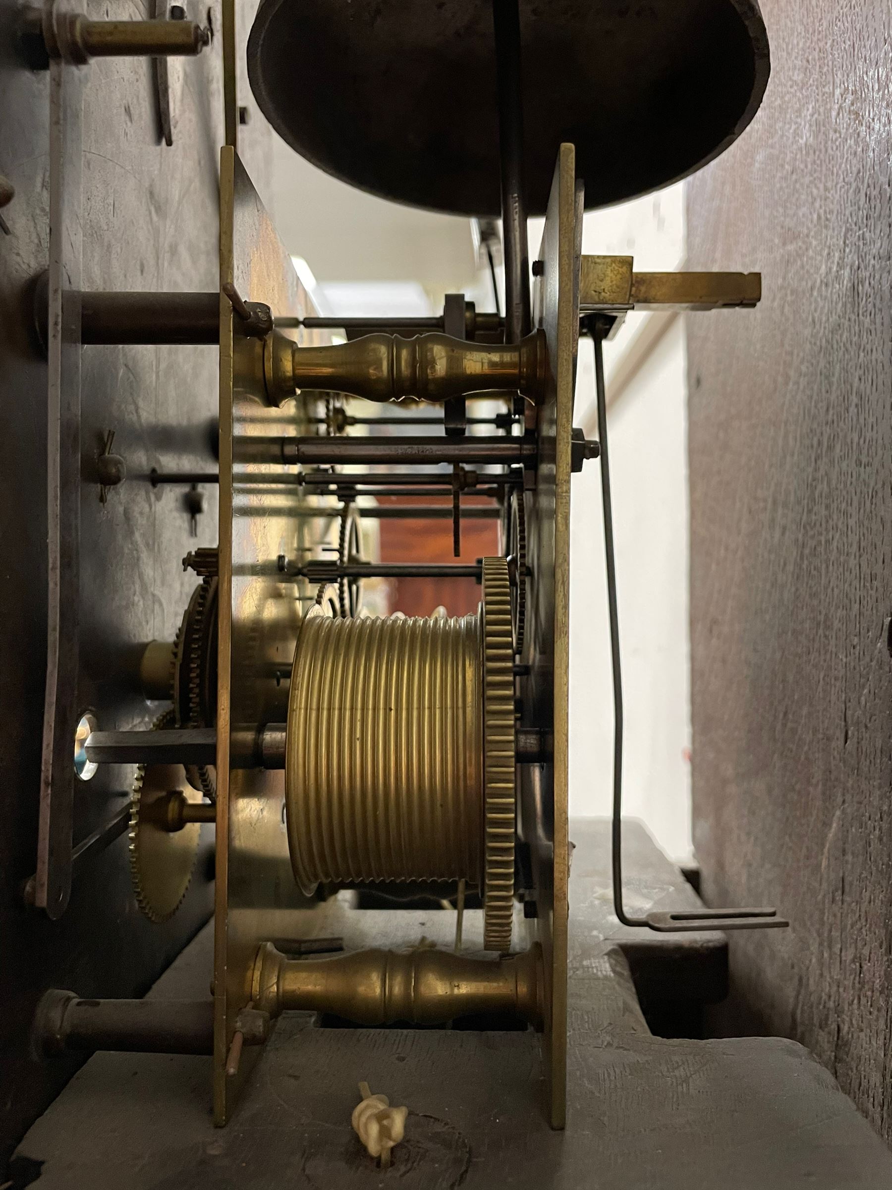 Henry Hindley of York – mid-18th century oak cased 8-day longcase clock,
flat topped caddy pediment with gesso finials, rectangular hood door flanked by wooden turned pilasters with capitals, canted trunk with a full-length break arch topped door on a short plinth with applied skirting and bracket feet, brass dial with a silvered chapter ring, Roman numerals and five-minute Arabic’s, minute and inner quarter hour tracks, matted dial centre with subsidiary seconds dial, blued steel hands and female head pattern spandrels, silvered calendar dial to the break arch with dolphin spandrels, four pillar rack striking movement, striking the hours on a bell. With weights and pendulum. 
H250 W48 D27
Henry Hindley originally from Wigan (Lancs) is recorded as working in York from Petergate 1731-41 then Stonegate 1741-1771. A famous and highly innovative maker, often referred to as the “Tompion of the North.” 
