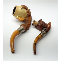 A carved meerschaum pipe depicting a lady in a tricorn hat with a silver hallmarked collar, in original case, along with a carved meerschaum pipe depicting a eagle claw with a hallmarked silver collar, in original case.  