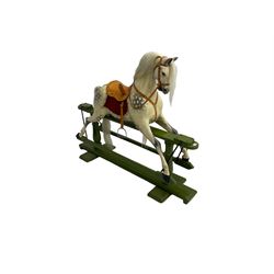 Attributed to F. H. Ayres - early 20th century carved wooden dapple grey rocking horse, with leather saddle and tack, with glass eyes, on green painted trestle base with turned column supports