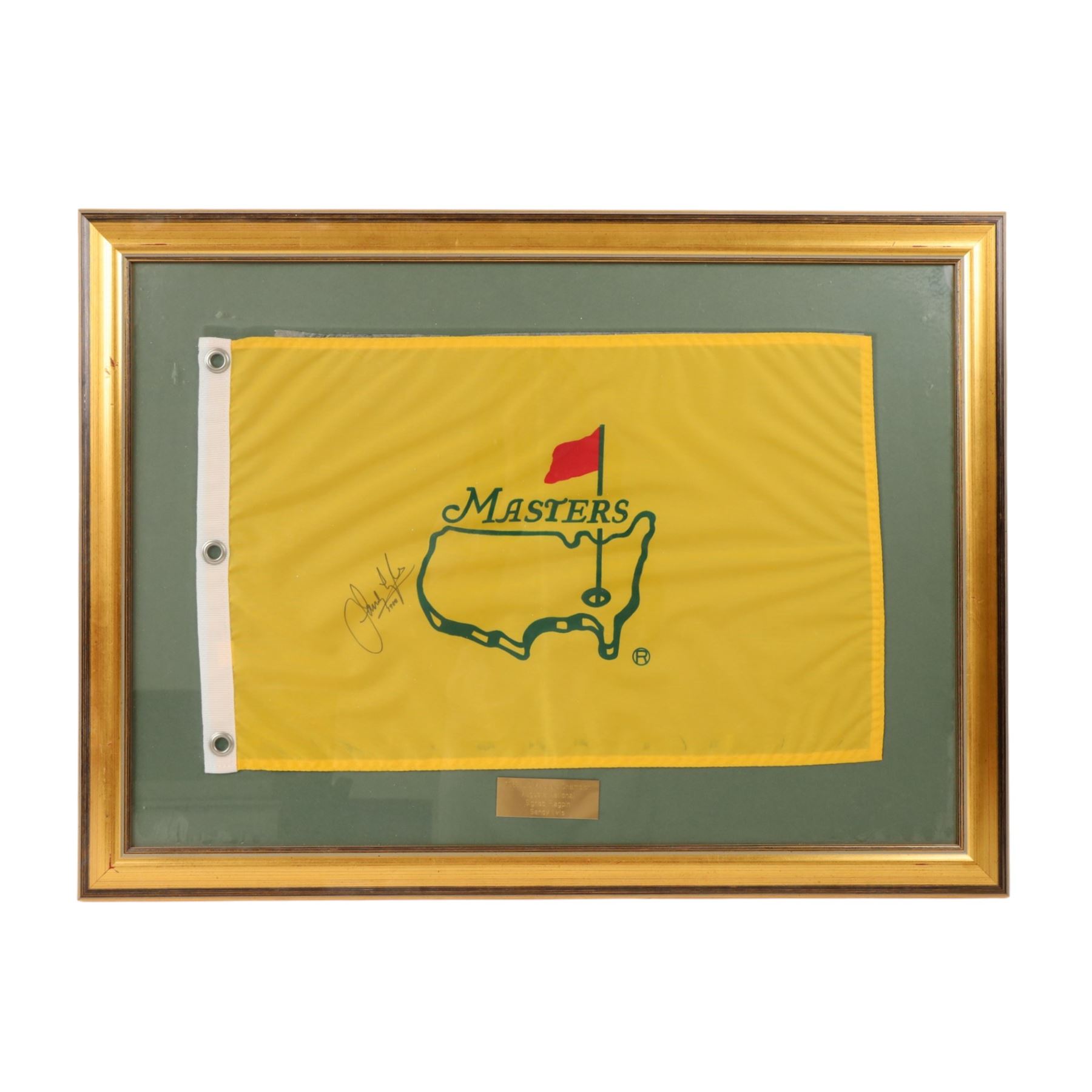 Signed golf memorabilia, to include 1988 US Masters Champion Augusta National flag, signed by Sandy Lyle, a golfing glove signed by Nick Faldo, two signed 2002 Ryder Cup prints, 1979 Masters scorecard signed by Fuzzy Zoeller displayed with a 1980 Masters scorecard signed by Seve Ballesteros, all framed, largest frame H60cm