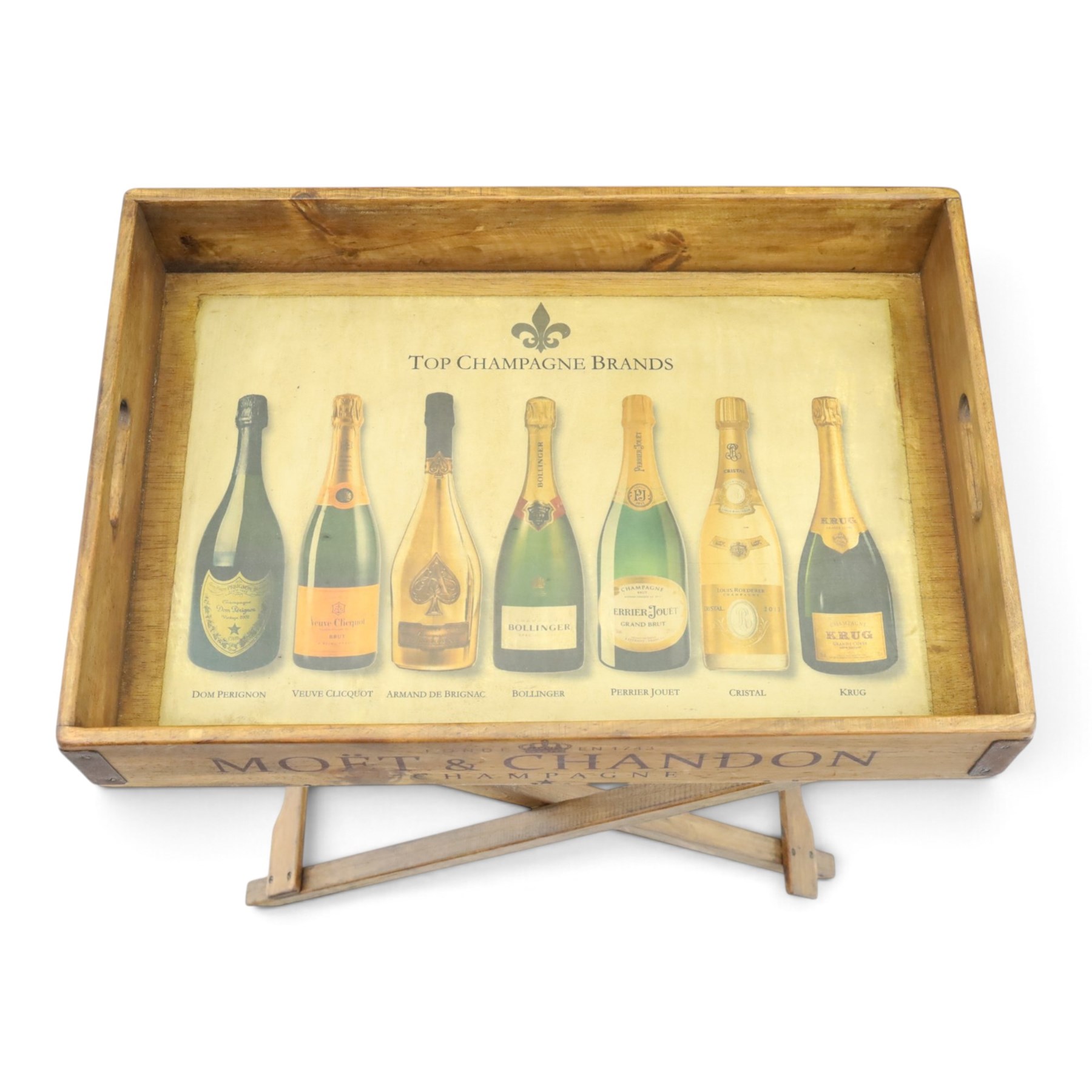 Champagne butler’s tray on stand, the wooden tray printed with champagne bottles and brand names, with cutout handles, raised on a folding stand