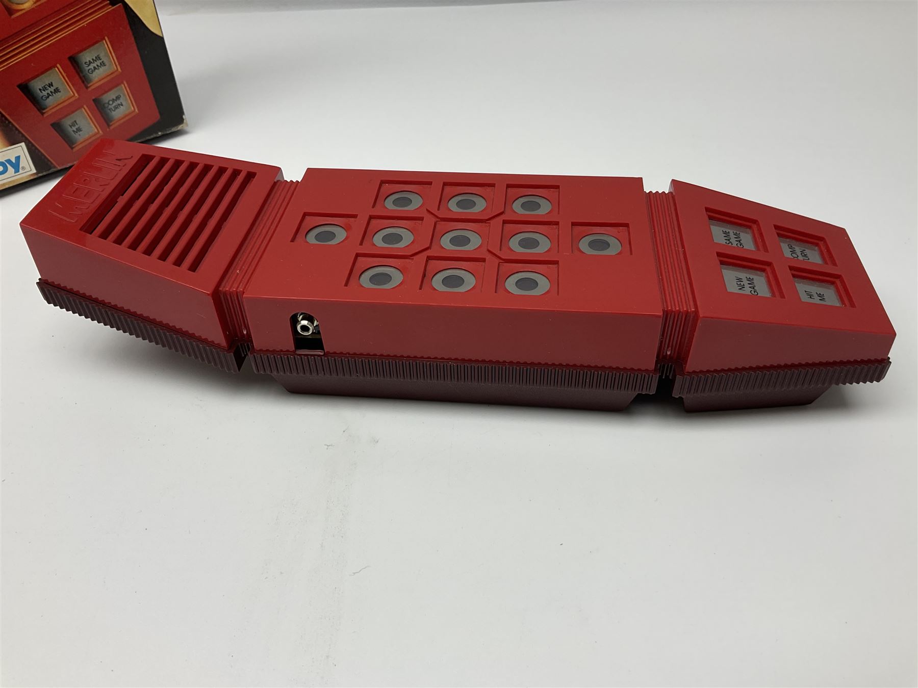 Three late 70s/early 80s handheld electronic games; Bandai Electronics Arcade ‘Gunfighter’ (1980), Grandstand ‘Invader From Space’ (1980), Palitoy ‘Merlin The Electronic Game Machine’ (1979) with game sheet and instruction booklet, all with original boxes (3) 