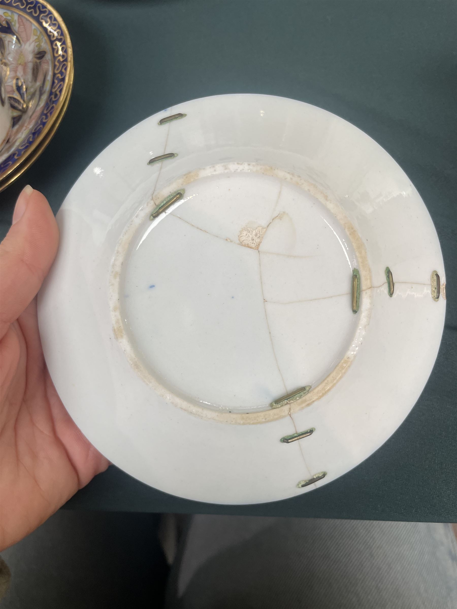 English porcelain Imari tea and coffee wares, pattern 1277, decorated with central orange floral motif surrounded by sprigs of yellow foliage within blue borders, comprising eleven teacups, eight coffee cups, twelve saucers, two shallow bowls and one finger bowl