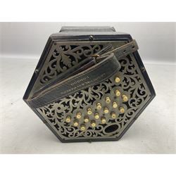19th century Lachenal concertina of hexagonal form with fretworked nickel ends and thirty-four plus one bone buttons; straps marked Lachenal & Co Makers London and wooden handle stamped English Make Trade Mark L16cm