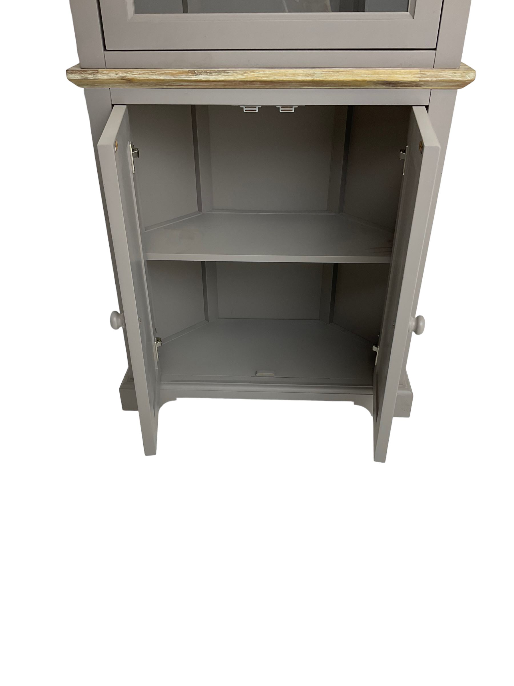 Contemporary teal and oak finish corner cabinet, single glazed door enclosing two shelves, over two panelled cupboard doors