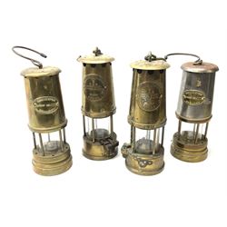 Four miner's lamps - two all brass by The Protector Lamp & Lighting Co. Ltd.H25cm; and two (one all brass and one brass/steel) bearing Ashington Colliery plaques (4)