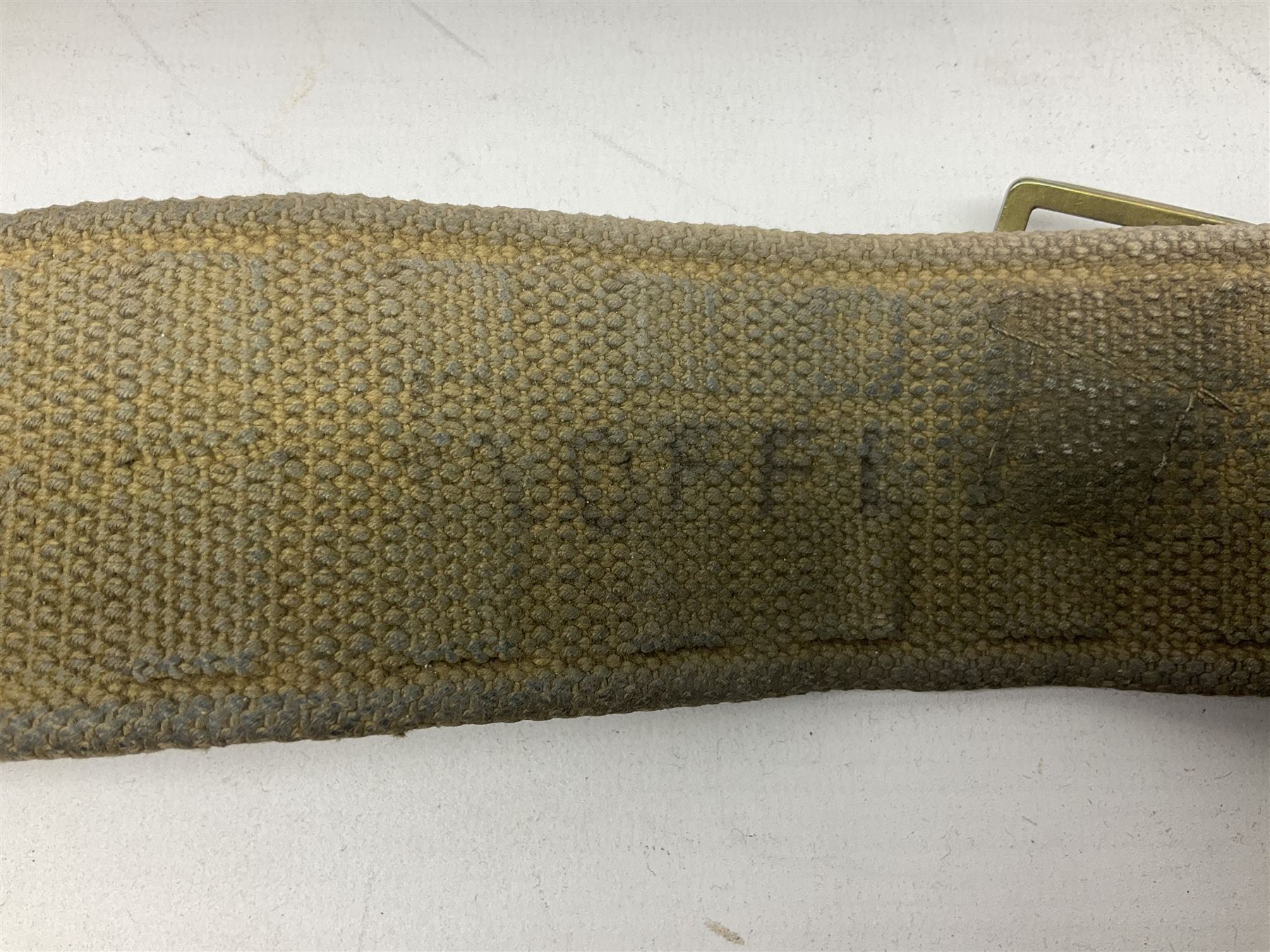 WW2 British black felt beret with Pioneer Corps cap badge, with Kangol Wear maker's mark dated 1943; and a British Army green webbing belt (2)