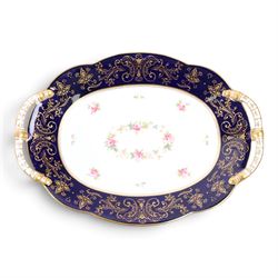 Coalport set of ten plates and four serving plates, each decorated with floral sprigs within a cobalt blue boarder with gilt detail, plates D22cm