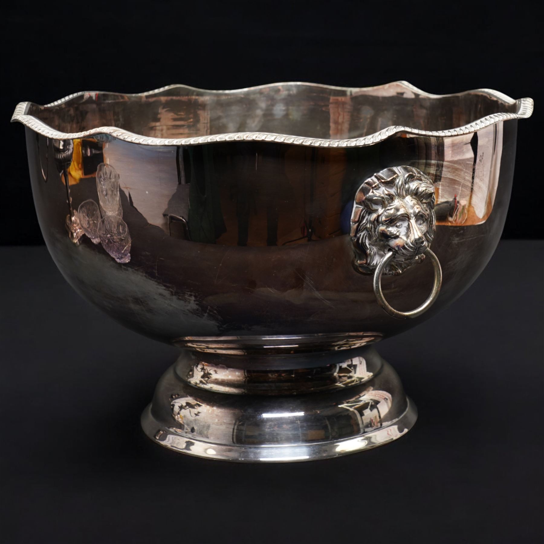 Silver plated four branch centrepiece set with glass bowls and a larger centre bowl and with interchangeable candle sconces H37cm  and a plated punch bowl with lion mask handles D37cm (2)