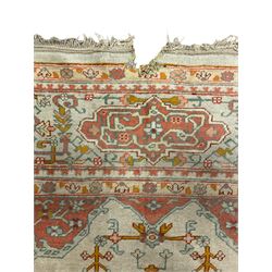 Large Persian pale sage ground carpet, the field decorated with central geometric medallion and tree of life motifs, the border with repeating geometric design decorated with stylised plant motifs