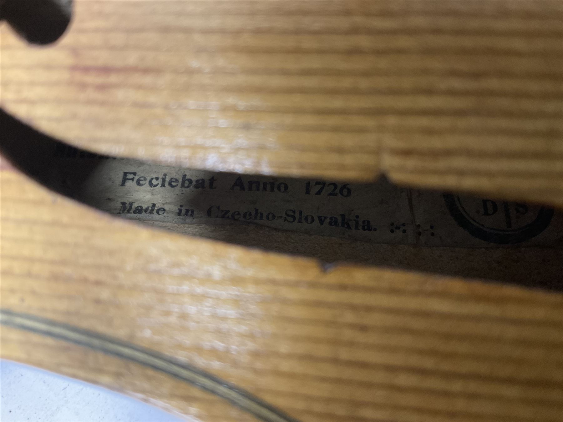 Copy of a full size Stradivarius violin, with an ebonised fingerboard, tailpiece and tuning pegs Length 60cm