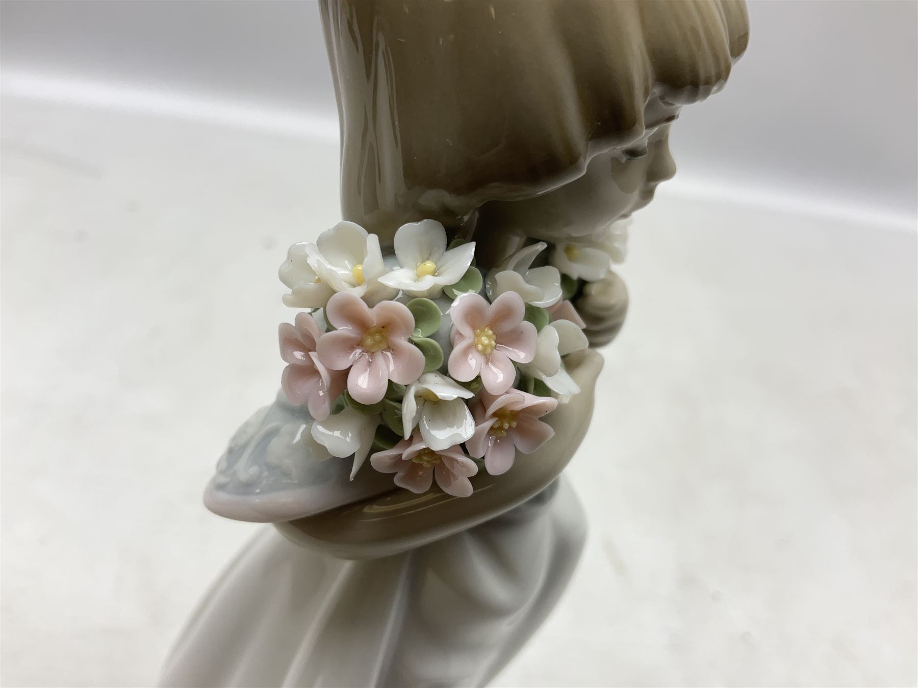 Three Lladro figures comprising, Pocket Full of Wishes no 7650, School Days no 7604 and Spring Bouquets no 7603, all with original boxes, largest example H26cm  