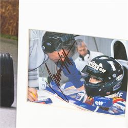 Ten signed Formula 1 photographs, comprising eight Damon Hill examples, Jenson Button and a Nigel Mansell example, nine with certificates of authenticity from Write Stuff Autographs, all framed, largest H47cm, W67cm