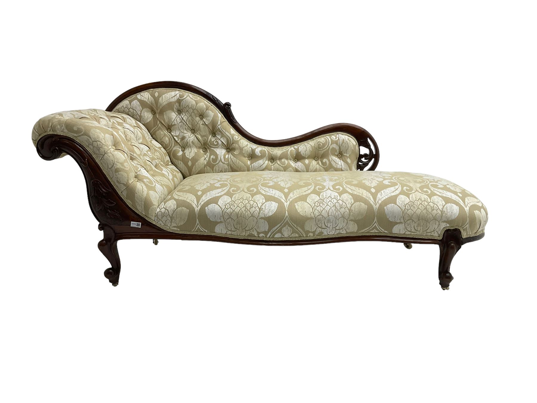 Victorian mahogany chaise longue, scrolled back with pierced and floral carved decoration, champagne foliate pattern fabric, cabriole feet with brass and ceramic castors