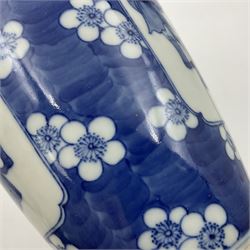 Late 19th century Chinese blue and white jar and cover, of slender ovoid form with domed cover, decorated with two reserves containing figures, against a prunus blossom ground, with Kangxi type mark beneath, H27.5cm