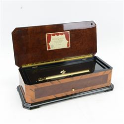 Reuge Sainte-Croix- 21st century Swiss musical box with a highly polished lacquered finish, inlaid and ebonised case with a glazed internal viewing lid, polished steel 144 teeth two-part comb playing three arias from The Phantom of the Opera by Lloyd Webber, with tune indicator and tune sheet.
