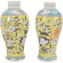 Pair of Chinese vases, of baluster form decorated with dragons amongst flowering peonies upon yellow ground, between bands of foliage, H24cm 