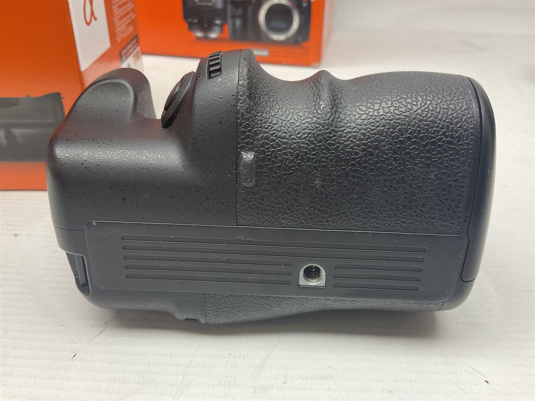 Sony Alpha A700 camera body, serial no 2340937, Sony Alpha A77 camera body, serial no 0715406, together with Sony angle finder and two firm holding grips, all with original boxes  