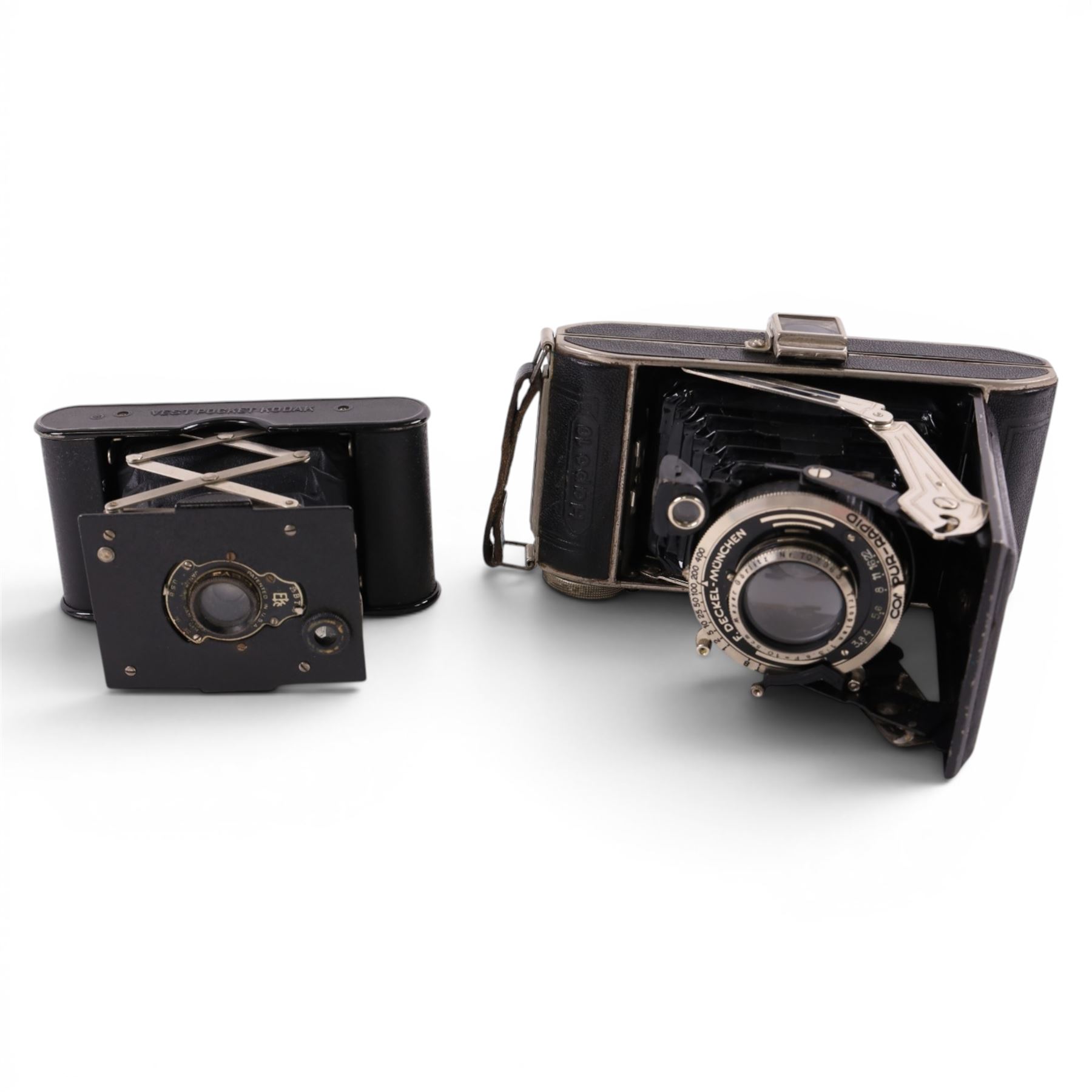 Three cameras, including Kodak Vest Pocket Camera A-127, Zenit E and a Hapo 10 and a Smiths Empire pocket watch 