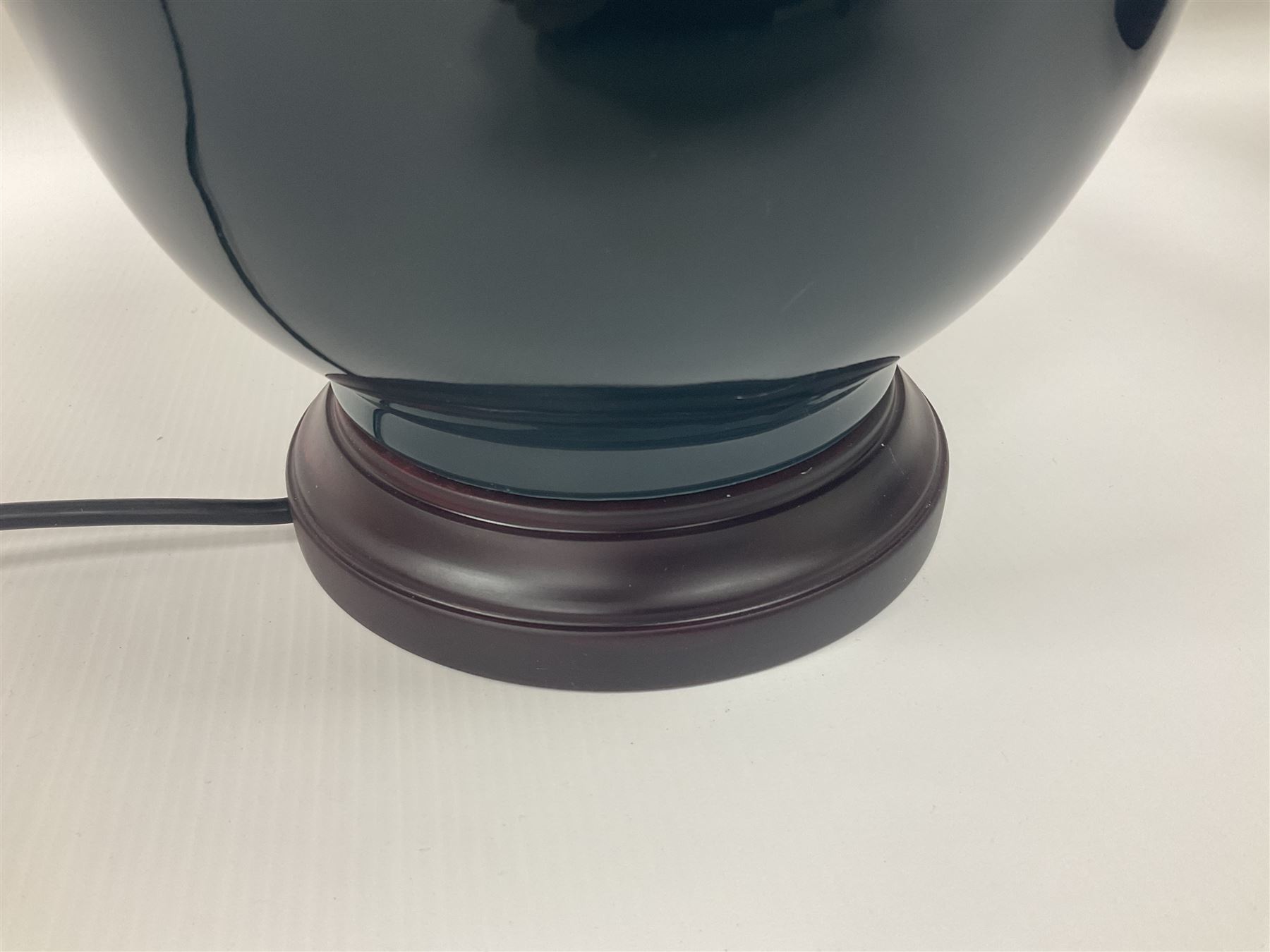 Pair of Chinese teal glazed table lamps, each of bottle form, raised upon circular hardwood bases, including shade H72cm 