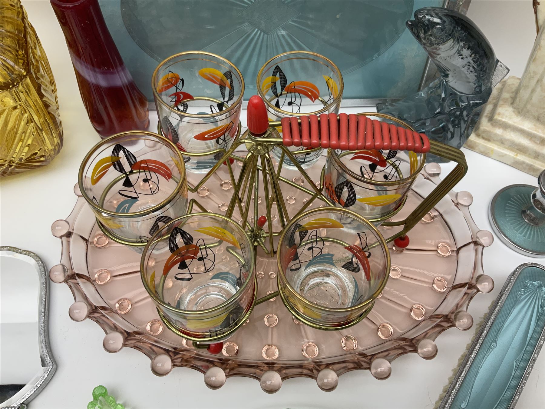 Swedish Svenskt Glass limited edition blue glass salmon, modelled by Paul Hoff, together with two vintage moulded coloured glass dressing table sets with jars and trays, spinning shot glass holder with abstract design glasses and an Art Deco vase, etc 