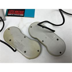 Two Super Nintendo Entertainment System (PAL) controllers, accessories and games. Super NES Game Commander with original box and instruction booklet, Super NES Nintendo Scope (1992) transmitter gun, receiver, Super NES Nintendo Scope 6 game with original instruction booklets. Further games to include ‘The Legend of Zelda a Link to the Past’, ‘Super Mario World’, ‘Super Mario Kart’, ‘The Lawnmower Man’, and ‘Exhaust Heat’, all with original instruction booklets. ‘PowerMonger’ and Disney’s ‘Aladdin’ game cartridges only 