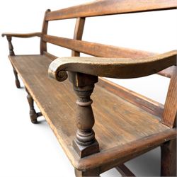 Early 20th century pine and oak bench seat, stained pine rail back frame with shaped oak arms