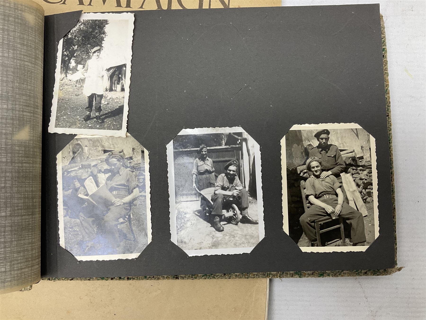 Modern album containing over sixty postcards and photographs including memorial portraits of KIA soldiers, regimental crests, comic, WW1 embroidered silk, uniforms, cap badges, camp and manoeuvre images etc; another personal photograph album of WW2 soldiers relaxing; Royal Armoured Corps booklet 'The Italian Campaign 3rd Sep. 1943 - 2nd May 1945; and other paper ephemera of military interest
