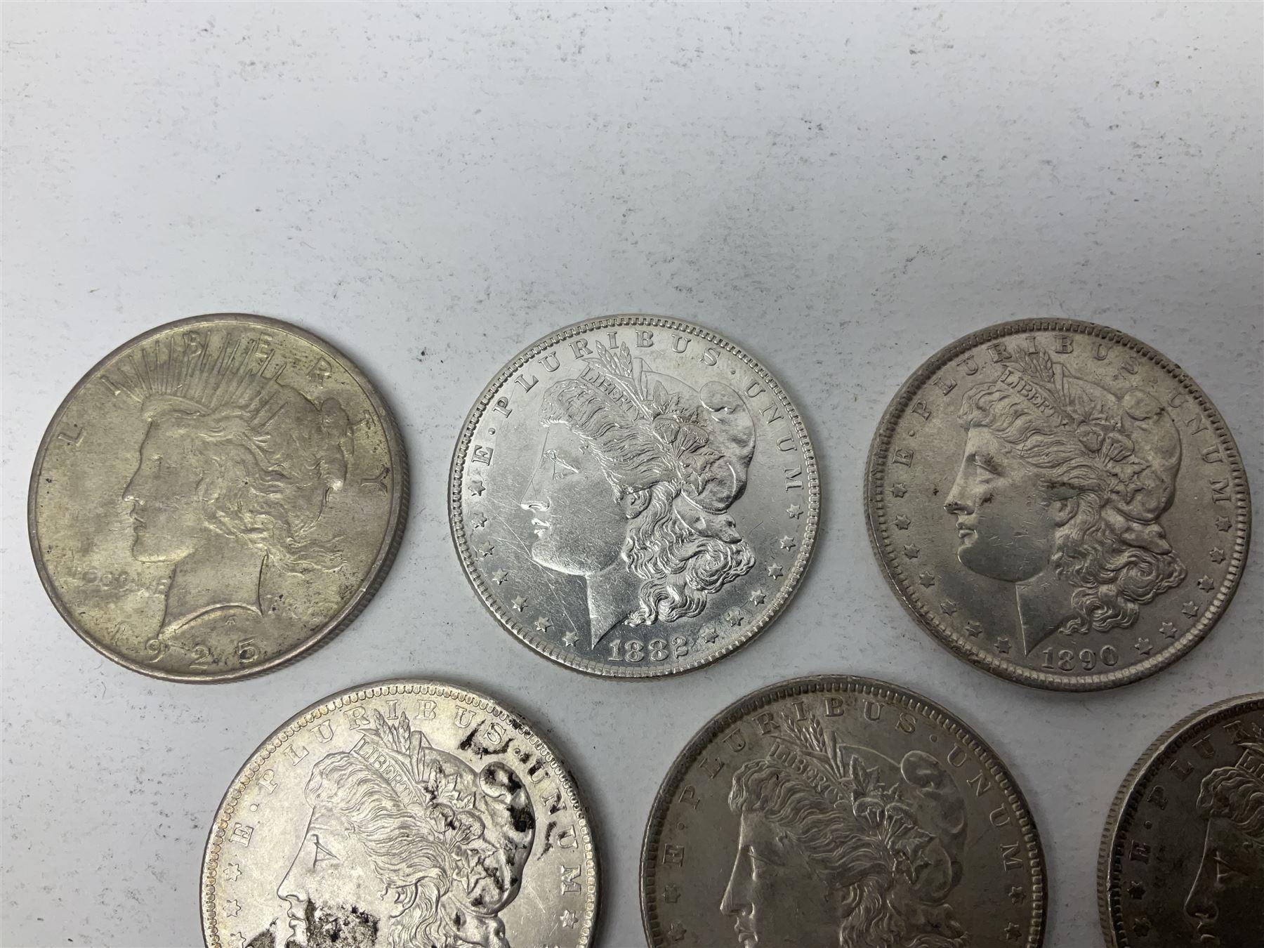 Eight United States of America silver Morgan dollar coins, dated 1882, 1884 O, 1884, 1885, two 1886, 1889, 1890 and a 1925 peace dollar
