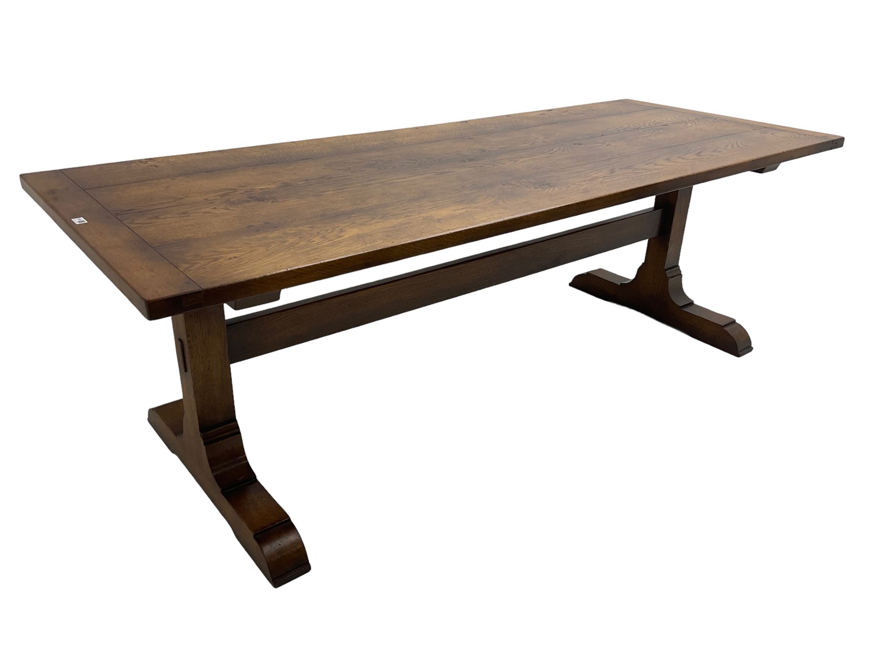 Dorset Oak - large refectory dining table, rectangular plank top, raised on shaped end supports with sledge feet, united by stretcher