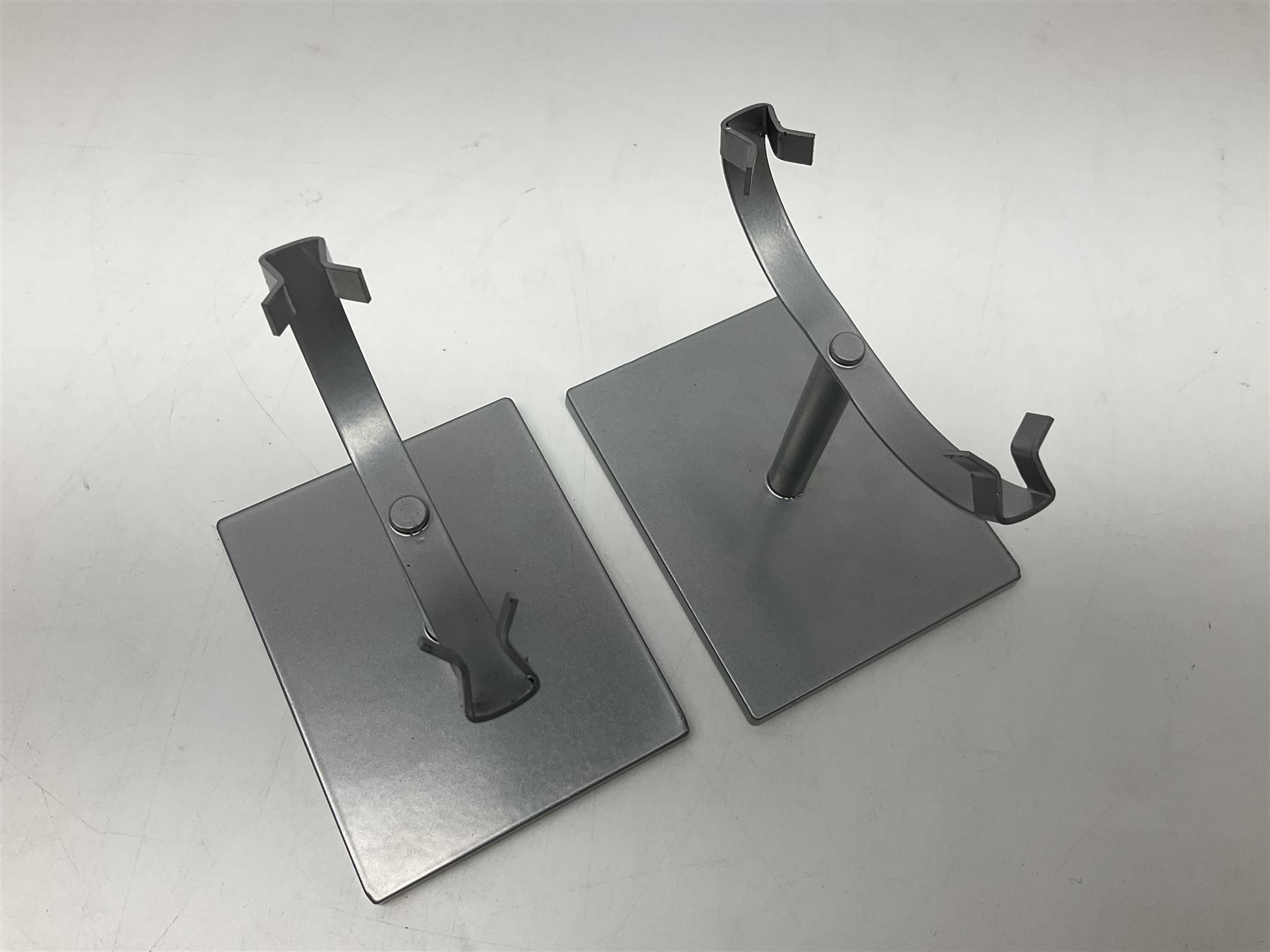 Pair of green agate slices, polished with rough edges raised upon silvered metal stands, H19cm