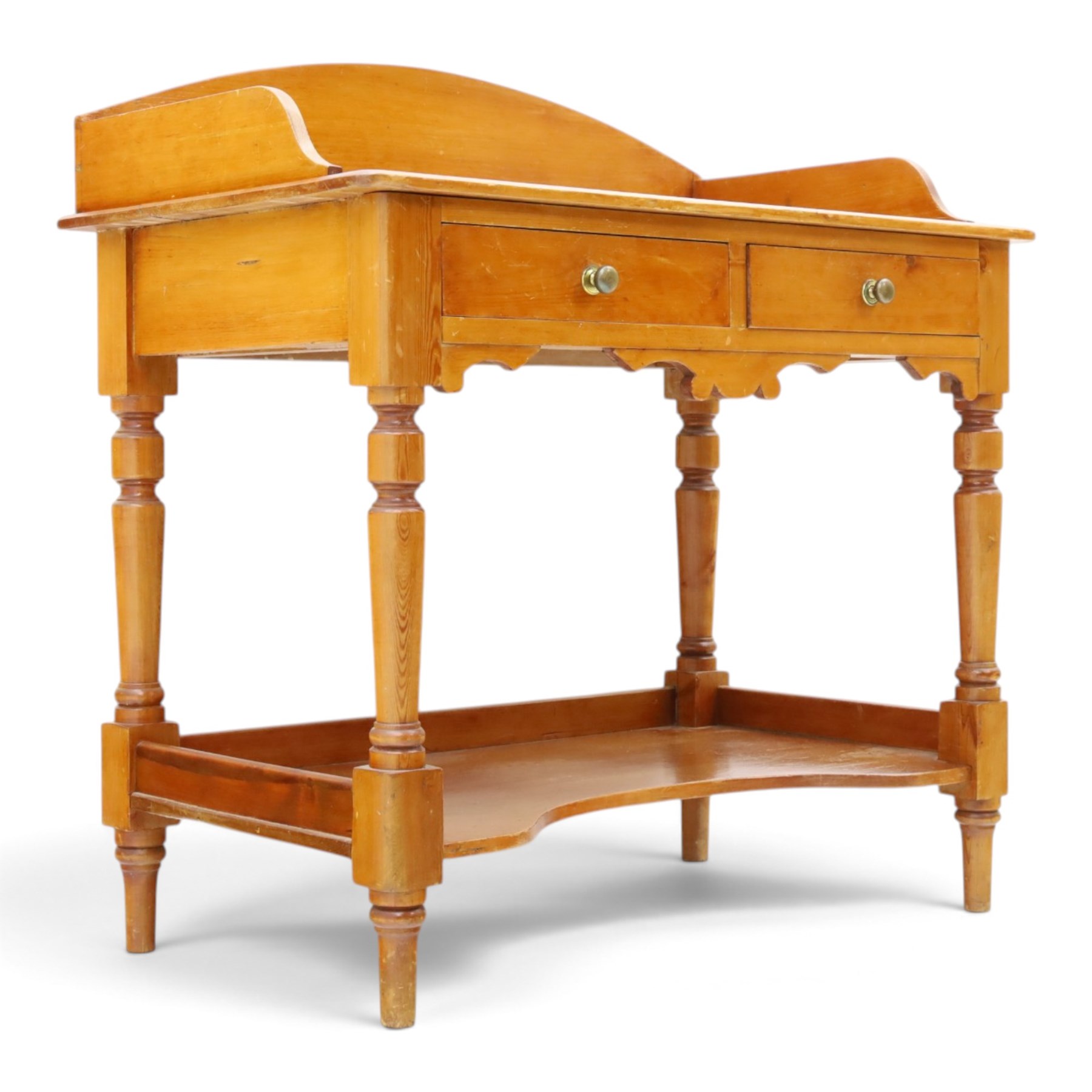 Victorian pine washstand, raised three quarter galleried top, fitted with two drawers, raised on turned supports united by a shaped full length under tier 