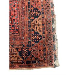 Small Afghan red and indigo rug, the main field decorated with stars and stylised plant motifs, the border bands decorated with geometric motifs