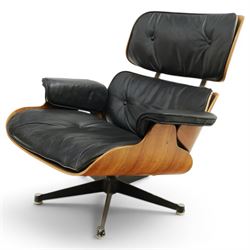 Charles and Ray Eames for Herman Miller - lounge chair, moulded veneered plywood shell with buttoned black leather upholstery, separate headrest and back cushions, padded armrests, on black cast aluminium five-star swivel base, manufactured under licence by Hille of London