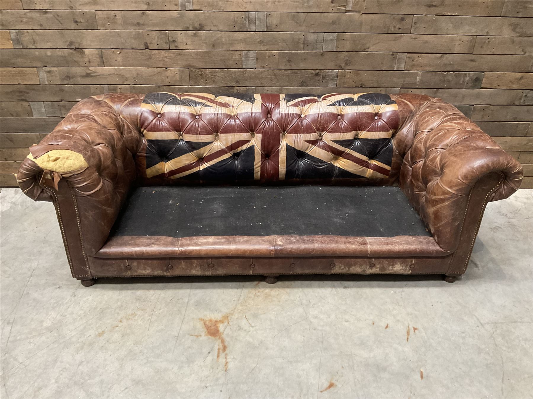 Chesterfield two sofa upholstered in brown leather, with Union Jack pattern, no seat cushions - located in storage, viewing not available