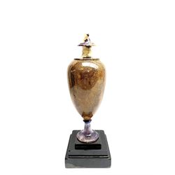 Early 19th century and later Blue John urn, Winnats one vein, of ovoid form with integrated cover and ball finial, upon a spreading circular base, and square stepped black lacquered base, H34.5cm