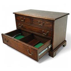 T & G style solid oak television cabinet, rectangular moulded top over two short and two long drawers with brass swing handles, the upper frieze drawer front hinged and fitted with stay to reveal pull-out shelf, open compartment above with circular cable aperture to rear, on bracket feet