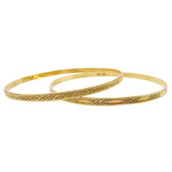 Two Middle Eastern 18ct gold bangles, with bead decoration